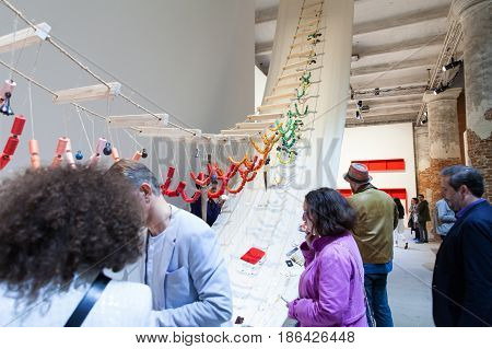 VENICE ITALY - MAY 10: Visitors interact with David Medalla's A Stitch in Time at the 57th Venice Biennale on May 10 2017