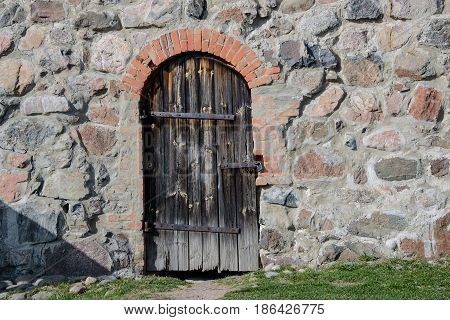 Old stonework of door into the Fortress Korela (Russian, Swedish and Finnish centuries), stone building in the city of Priozersk, on island of the river Vuoksi. A historic heritage place for tourism.