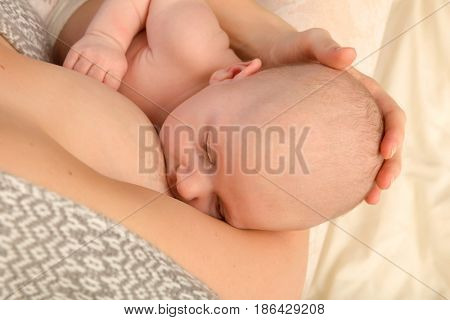 Closeup of a baby of 7 weeks old being breastfed