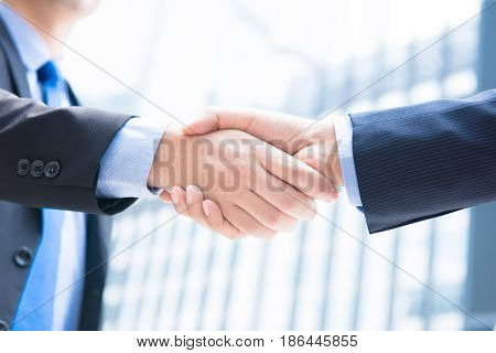 Businessmen making handshake - greeting dealing merger and acquisition concepts