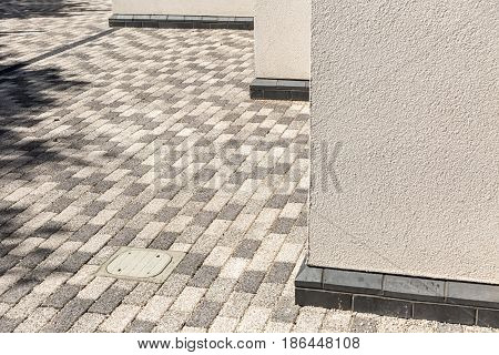 Architectural Corner detail of white modern rendered building with pavement floor pattern