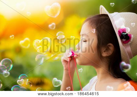 Asian kid play bubble with morning sunrise and nature background