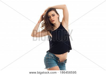 sensual brunette girl with unbotton jeans shorts looking at the camera isolated on white background