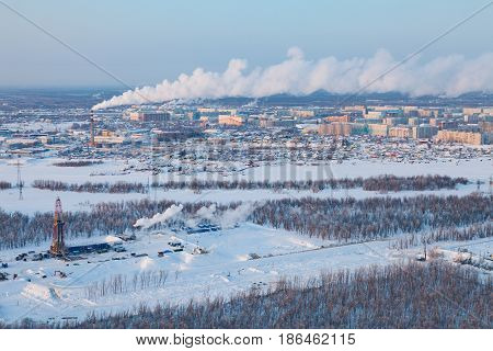 Aerial view of oil rig at an oil field on Megion town background in Western Siberia in the winter