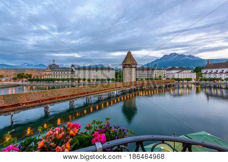 Night view towards Chapel Bridge (Kapellbruecke) together with the octagonal tall tower (Wasserturm) it is one of the Lucerne's most famous tourists attraction