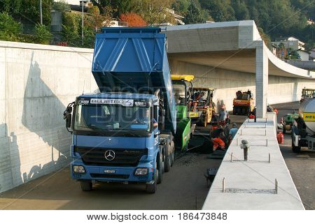 Workers And Vehicles During The Asphalting Of The Highway