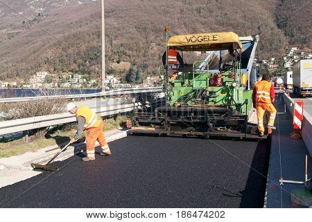 Workers And Vehicles During The Asphalting Of The Highway