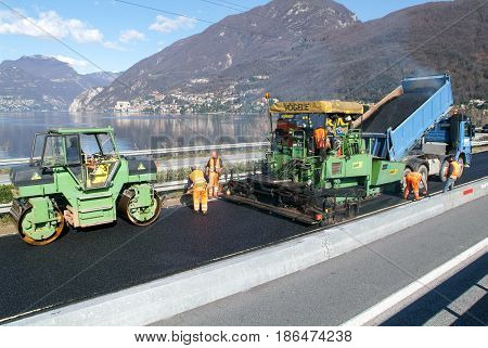 Workers And Vehicles During The Asphalting Of The Highway