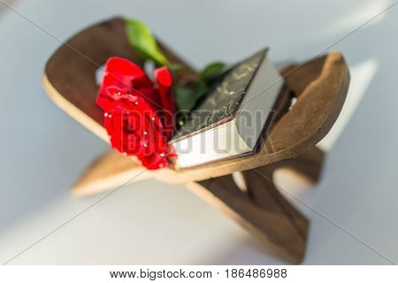 holy kuran and red flower on stand