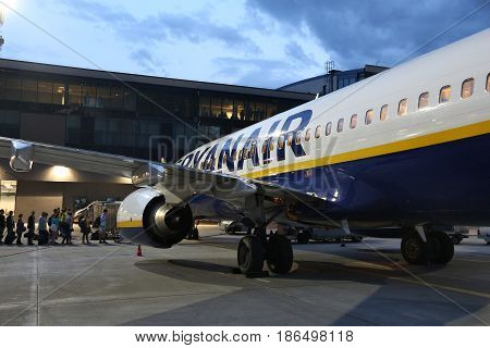 KATOWICE POLAND - JULY 5 2016: People board Ryanair Boeing 737NG in Katowice Airport in Poland. Ryanair is one of biggest airlines in the world with fleet of 393 Boeing 737.