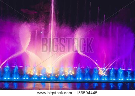 Multicolored Dancing Water Jet Fountain In The Dark