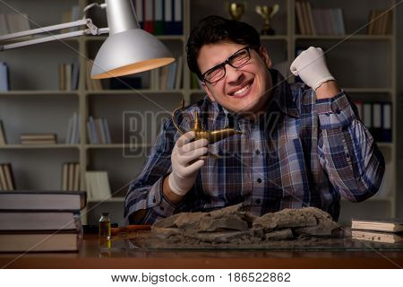 Archeologist working late night in office