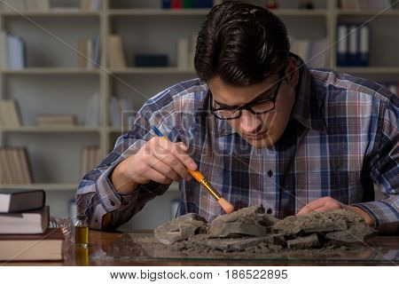 Archeologist working late night in office