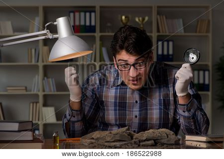 Archeologist working late night in office