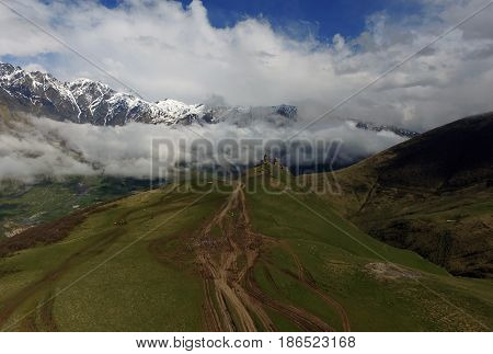 Gergeti Trinity Church Or Tsminda Sameba - Holy Trinity Church Near Village Of Gergeti In Georgia. Church Is Situated At An Elevation Of 2170 Meters Under Mount Kazbegi. Spring Or Summer Season.