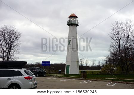 NEW BUFFALO, MICHIGAN / UNITED STATES - NOVEMBER 20, 2016: A tall lighthouse stands in the New Buffalo Welcome Center 707 rest area.