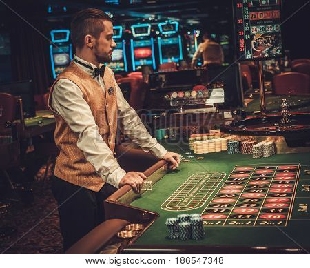 Dealer behind table in a casino
