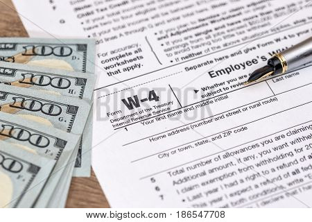 W4 Tax Form With Money And Pen.