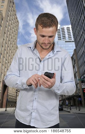 Handsome man using a cell phone for texting