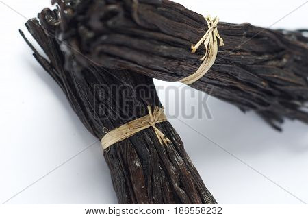 Two fresh bunches of Madagascar vanilla pods against a white background. Food grade and a great promo for articles or recipe ingredients list websites.