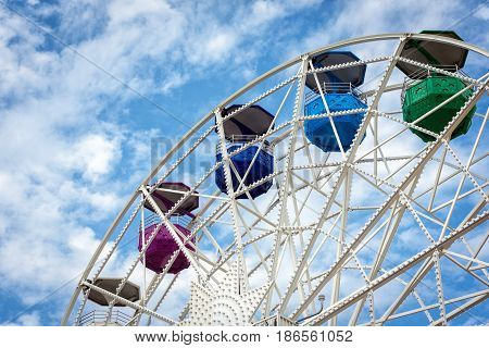 Ferris wheel and cloudy sky at mount Tibidabo in Barcelona, Spain