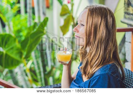 Young Beautiful Redhead Woman Sitting In A Cafe Drinking A Delicious Morning Ginger Tea In A Cafe
