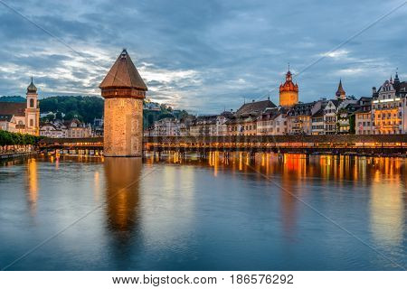 Night view towards Chapel Bridge (Kapellbruecke) together with the octagonal tall tower (Wasserturm) it is one of the Lucerne's most famous tourists attraction