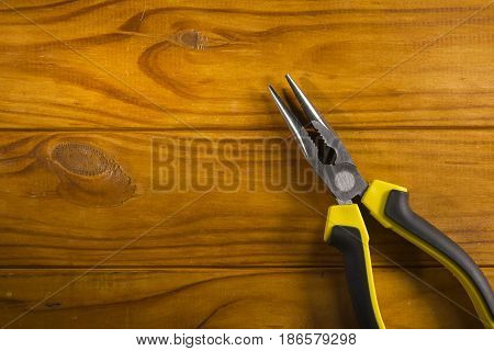 Close up of a multitool pliers on wooden background