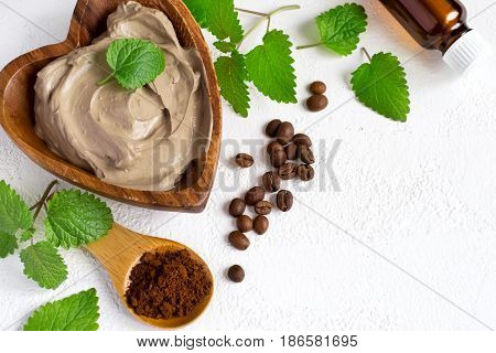 Spa setting with cosmetic clay mask for body, Towel  Essential oil and coffee beans