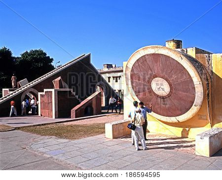 JAIPUR, INDIA - NOVEMBER 24, 1993 - People looking at the giant sundial known as the Samrat Yantra at Jantar Mantar Jai Singhs Observatory Jaipur Rajasthan India, November 24, 1993.
