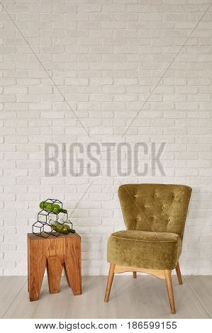 Green Armchair In Front Of The Brick Wall