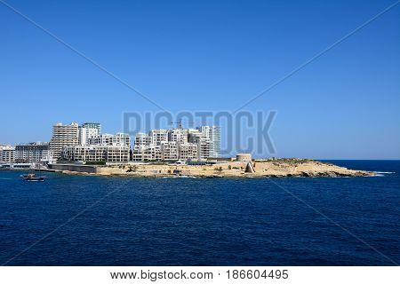 VALLETTA, MALTA - MARCH 30, 2017 - View of Fort Tigne with modern buildings to the rear seen from Valletta Sliema Malta Europe, March 30, 2017.