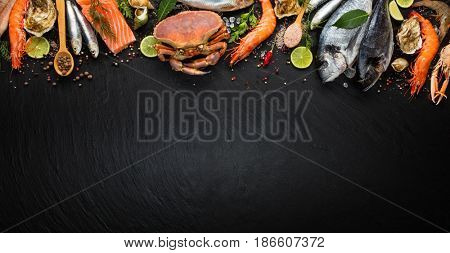 Fresh seafood, mussels, prawns, fish, crab, salmon steak, mackerel and other shells served on black stone