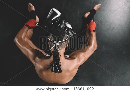 Top View On Muay Thai Fighter With Mongkhon On Head Sitting On Floor