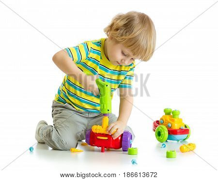 Cute child boy playing with educational isolated on white background.