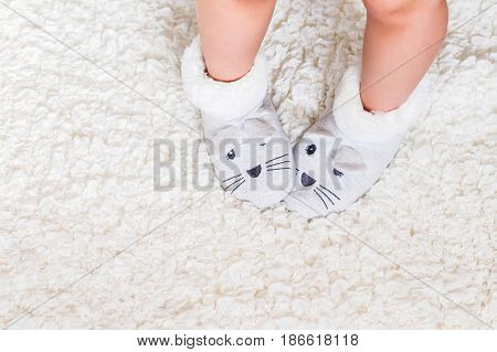 Child's feet in slippers above overhead top view