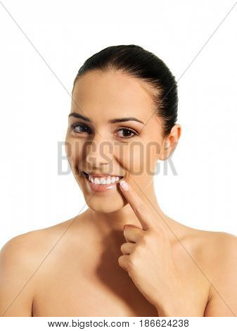 Dental health concept - beautiful woman pointing to her teeth