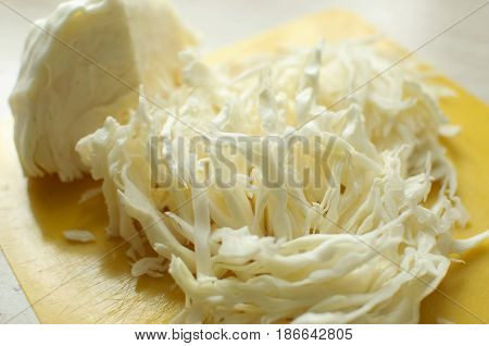 Sliced White Cabbage On A Yellow Cutting Board