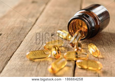 closeup supplements vitamins bottle on wood background