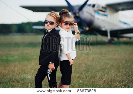 photo of young boy and girl playing spy
