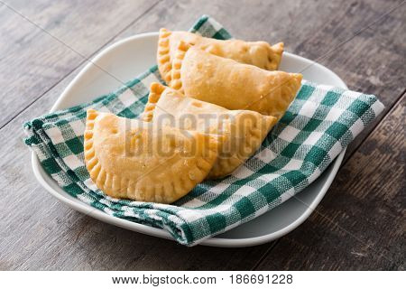 Delicious typical Spanish empanadas on wooden table