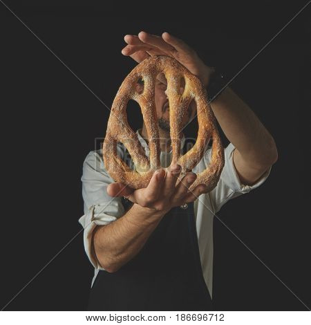 Baker holding fougas bread