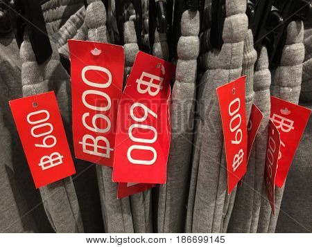 Colorful clothes hanging on a hanger and price tag with Thai baht