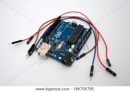 Arduino and around listed wire on a white background