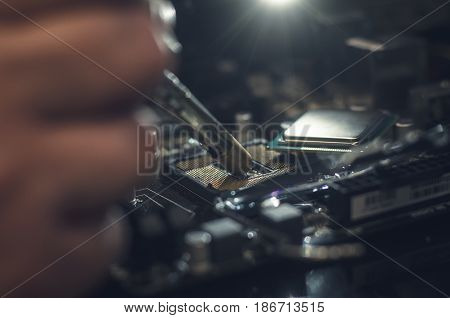 Computer processor. Technician works with CPU unmount from motherboard.