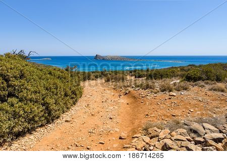 The dirt road strewn with large stones. The peninsula Kalydon. Crete. Greece.