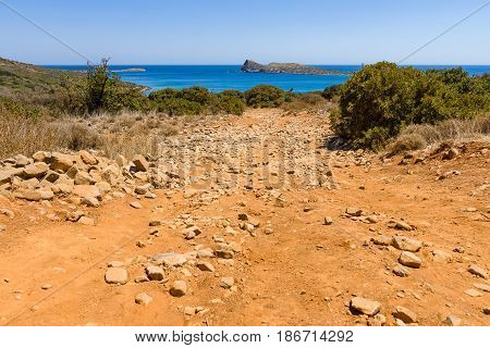 The dirt road strewn with large stones. The peninsula Kalydon. Crete. Greece.