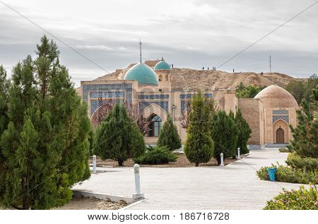 Namazgokh and Djuma mosque against the backdrop of the ruins of the fortress Nur. Nurata Uzbekistan