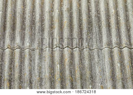 Asbestos cement sheets. Texture of old laid roofing sheets. Grey roof tiles.