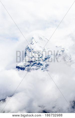 The Swiss Alps at Murren, Switzerland. Jungfrau Region. Tops of the mountains in fog and clouds.